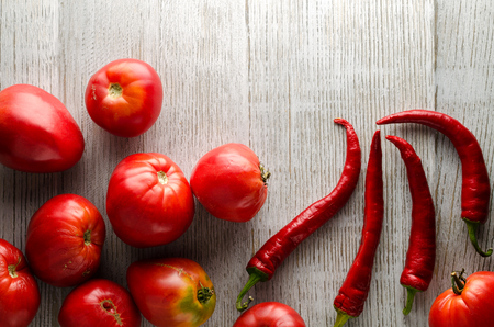 Healthy Food Background. Different Fresh Vegetables On A Wooden White Table With Empty Space For Text. Tomatoes, Red Hot Peppers. Top View .の写真素材