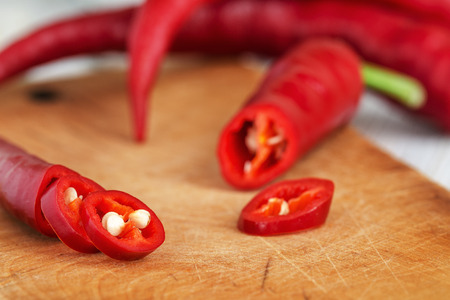 Fresh Red Hot Pepper Slices Cut On An Old Wooden Board. Macro.の写真素材
