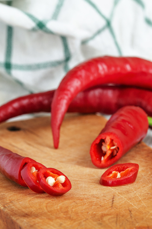 Fresh Red Hot Pepper Slices Cut On An Old Wooden Board. Macro.の写真素材