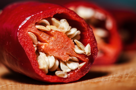 Fresh Red Hot Pepper Slices Cut On An Old Wooden Board. Macro.の写真素材