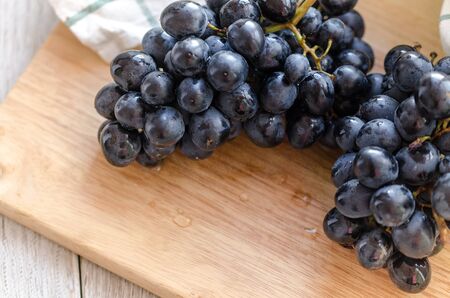 Fresh Black Grapes On A Wooden Board With A Blank Space For Text. Top View.の写真素材