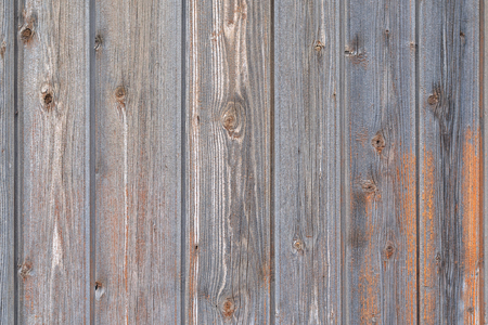 Old Gray Wooden Fence Partially Painted Orange Paint. Texture, Background Series.の写真素材