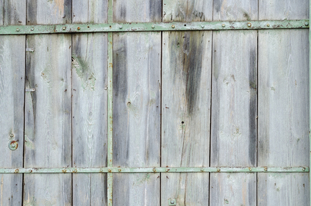 Old Wooden Fence With Peeling Off Paint With A Green Metal Fastening. Texture, Background Series.の写真素材