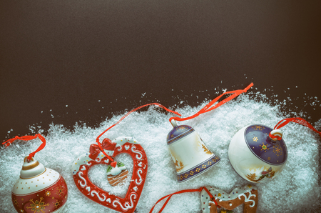Christmas Tree Decorations (Balls, Bells, Heart, Star, Gingerbread Men) In The Snow On A Black Background. Close-Up. Free Space For Text. Top View.の写真素材