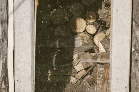 Stacked Logs In A Shed Behind The Glass. Vintage, Grunge Version.の写真素材