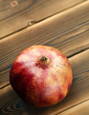 Red Pomegranate On A Wooden Board. Still Life. Close-Up. Free Space For Text.の写真素材