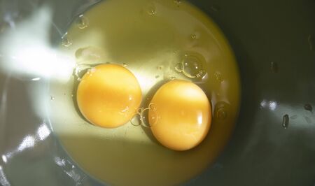 Two Egg Yolks In A Bowl On A Sunny Day. Close-Up. Macro.の写真素材