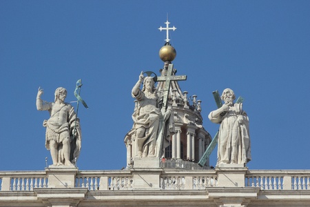 Statue of Jesus christ an saint john the baptist on the top of the facade of Saint Peter in Romeの写真素材