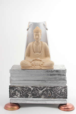 Statue of budda on a silver baseの写真素材
