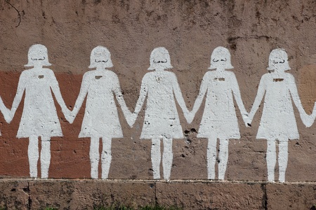 line of white dolls painted in a wallのeditorial素材