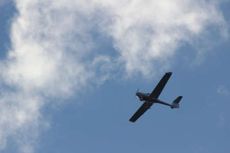 Airplane flying among clouds and blue sky