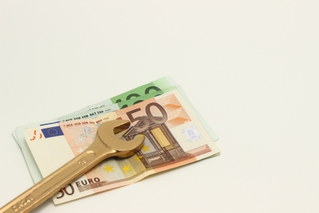 Gold wrench tool and rising cost of laborの写真素材