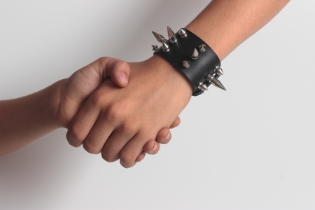 hand shaking with spikes' braceletの写真素材