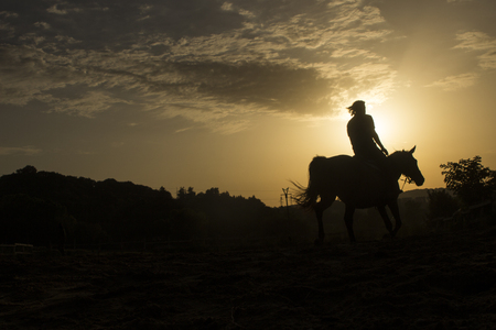 Horse riding silhouetteの写真素材