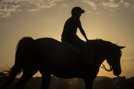 Horse riding silhouetteの写真素材
