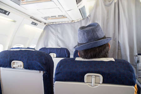 Aircraft cabin and passenger with hatの写真素材
