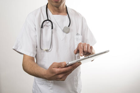 Nurse writing diagnosis on a tabletの写真素材