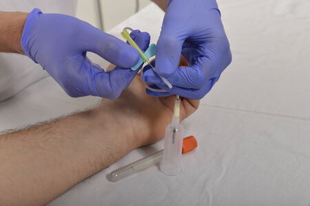 Nurse collecting bloodの写真素材