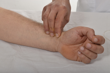 Nurse checking pulseの写真素材