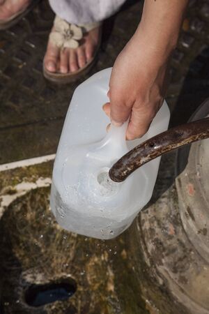 Filling canister public fountain, Rome, Italyの写真素材