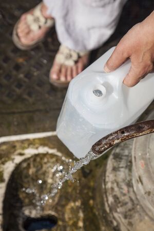 Filling canister public fountain, Rome, Italyの写真素材