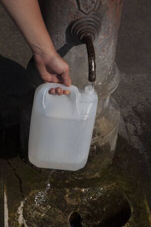Filling canister public fountain, Rome, Italyの写真素材