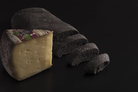 Black bread with vegetal carbon and cheeseの写真素材