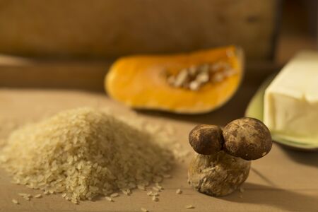 Pumpkin risotto ingredients on a wooden surfaceの写真素材