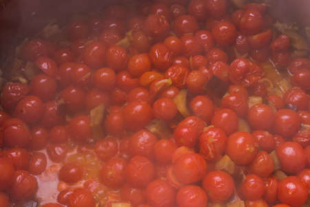 Boiling pachino variety tomatoes with eggplantsの写真素材