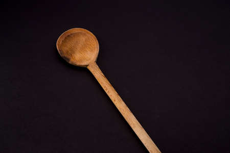 wooden cutlery isolated on blackの写真素材