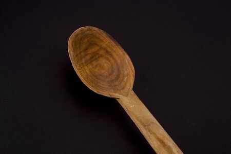 wooden cutlery isolated on blackの写真素材