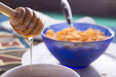 Morning breakfast with milk, corn flakes and honey