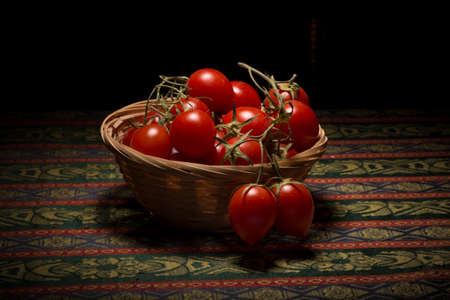 Basket of cherry tomatoes from Vesuvio under a kitchne lightの写真素材