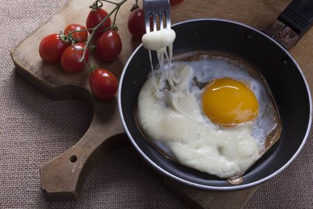 Fried eggs with cheese slicedの写真素材