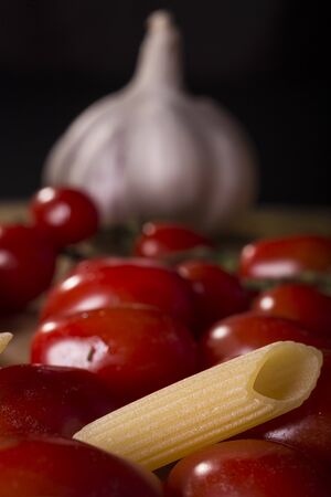 Pasta, garlic and tomatoes, basic ingredients for a tasty lunchの写真素材