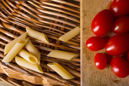 Pasta, garlic and tomatoes, basic ingredients for a tasty lunchの写真素材
