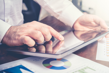 Businessman Analyzing Financial Statistics With Tabletの写真素材