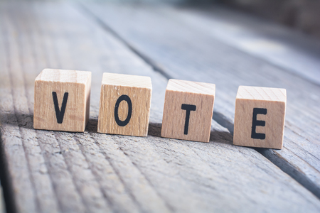 Macro Of The Word Vote Formed By Wooden Blocks On A Wooden Floor