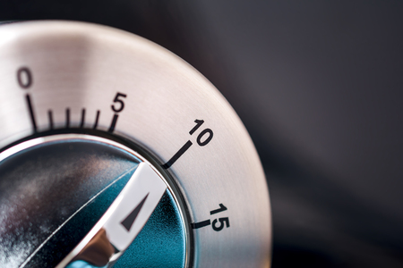 10 Minutes - Macro Of An Analog Chrome Kitchen Timer With Dark Backgroundの写真素材