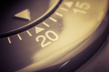 20 Minutes - A Macro Of A Flat Red Kitchen Egg Timer In Sepiaの写真素材