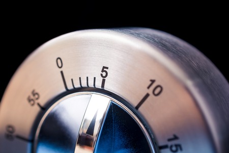 5 Minutes - A Macro Of An Analog Chrome Kitchen Timer With Dark Backgroundの写真素材