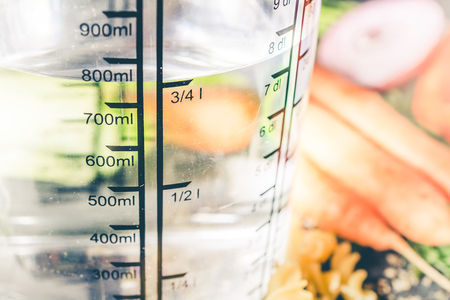 750 ml - ccm Water In A Measuring Cup Surrounded By Noodles, Onion, Carrots And Spicesの写真素材