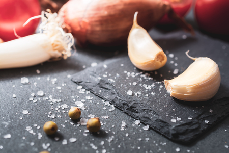 Kitchen Ingredients Like Garlic, Onion Or Spices On Slate Stoneの写真素材
