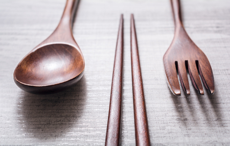 Wooden Set Of Chopsticks, Fork And Knife Lying Parallel To Each Other, High Angle Viewの写真素材