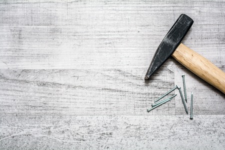 Tool Set Of Hammer And Nails On A Wooden Table - Top Down View With Copy Spaceの写真素材