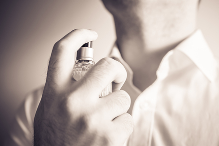 Businessman Using An Eau De Parfum Spray Bottle On His Neck, Monochrome Colorsの写真素材