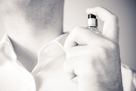 Businessman Using A Parfume Bottle On His Neck, Monochrome Colorsの写真素材