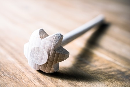 A Wooden Whisk Lying Down On A Table