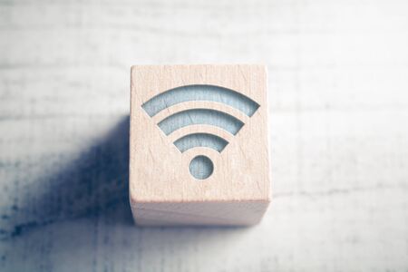 Macro Of A WIFI Icon On Wooden Block On A Tableの写真素材