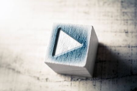 Macro Of A Play Icon On Wooden Block On A Tableの写真素材